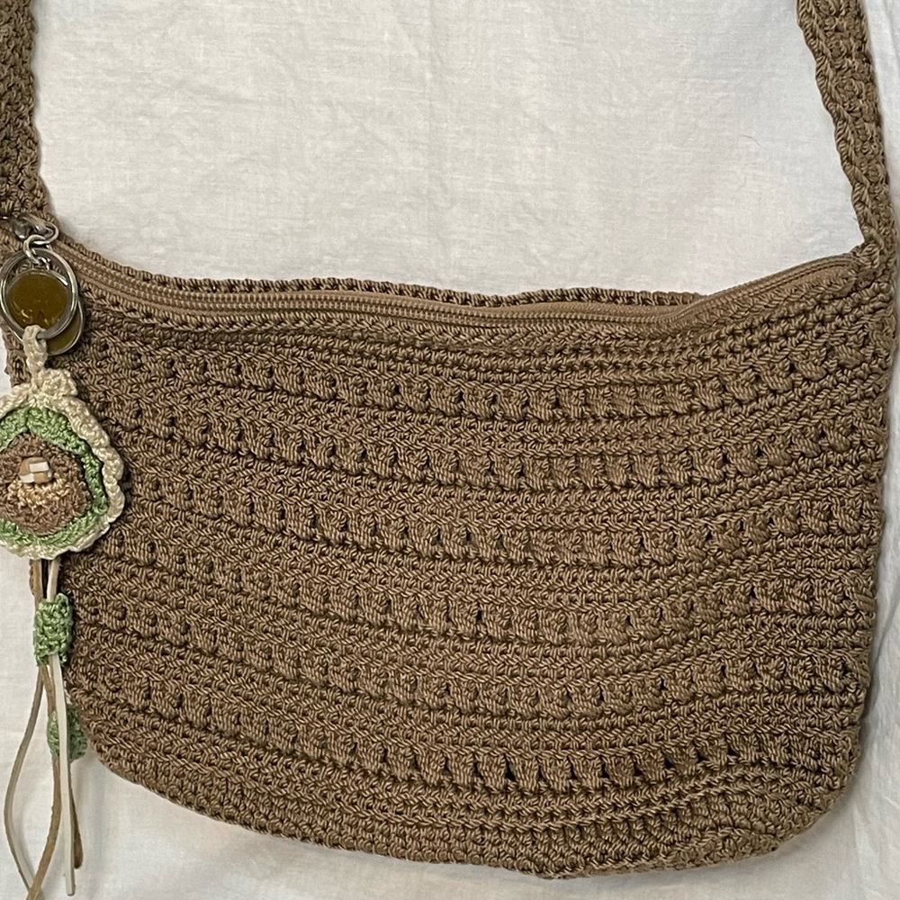 The Sak Crochet Shoulder Bag in Cognac color. Crochet Flower detail on zipper. - Picture 3 of 10